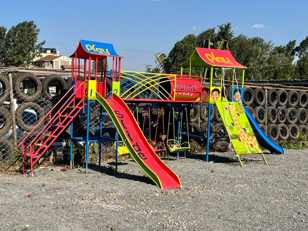 Salober Hotel's Kids Zone play structure with slide, tunnel and swings